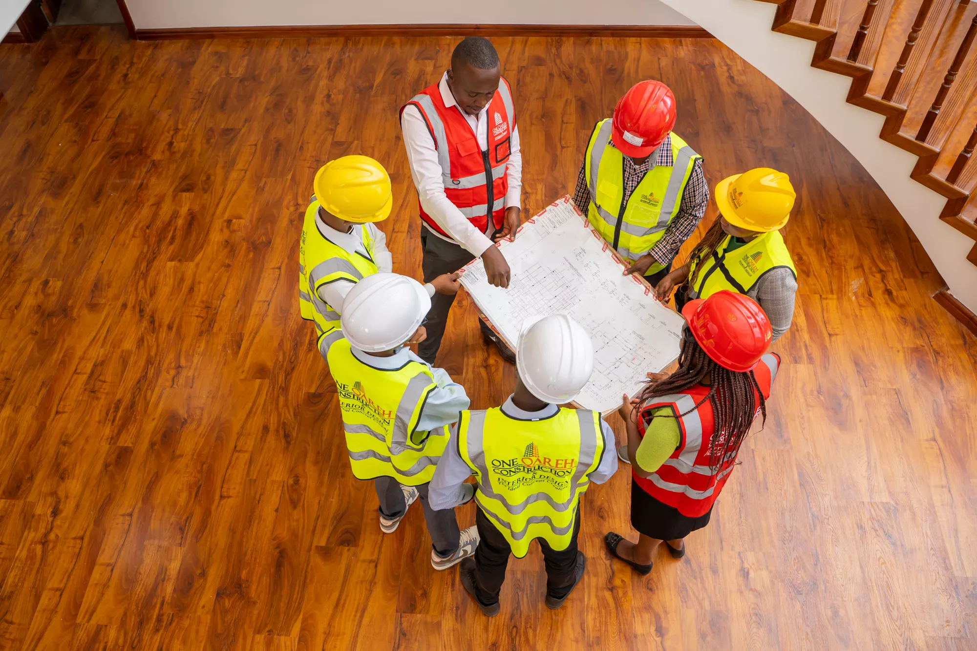 One Qareh team reviewing drawings on site